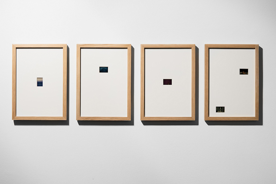 Four framed ateloprosopia works installed in a row